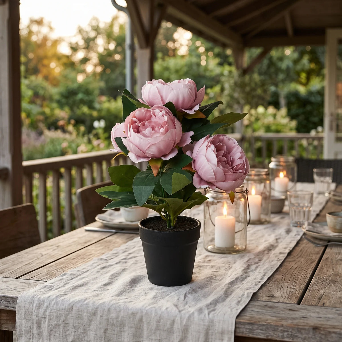 Artificial Rose Peony in Pot on a candlelit terrace dining table